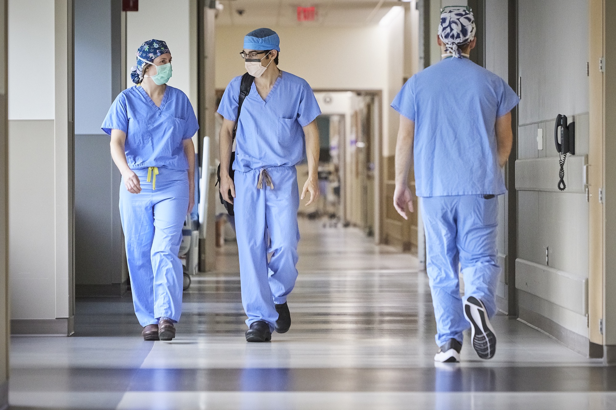 MCW clinicians walking together in an operating room corridor
